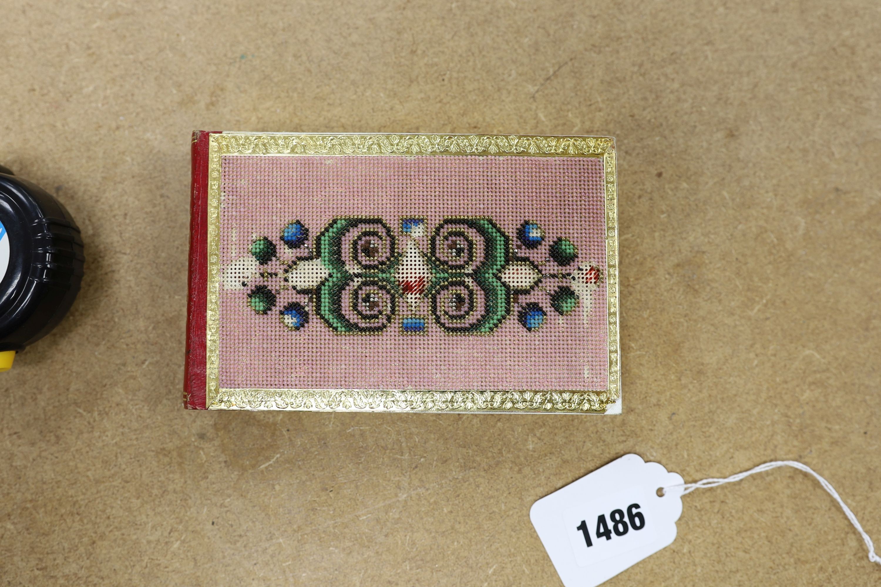 An Austrian beadwork cover souvenir album of watercolours and Berlin woolwork., 15 cms wide.